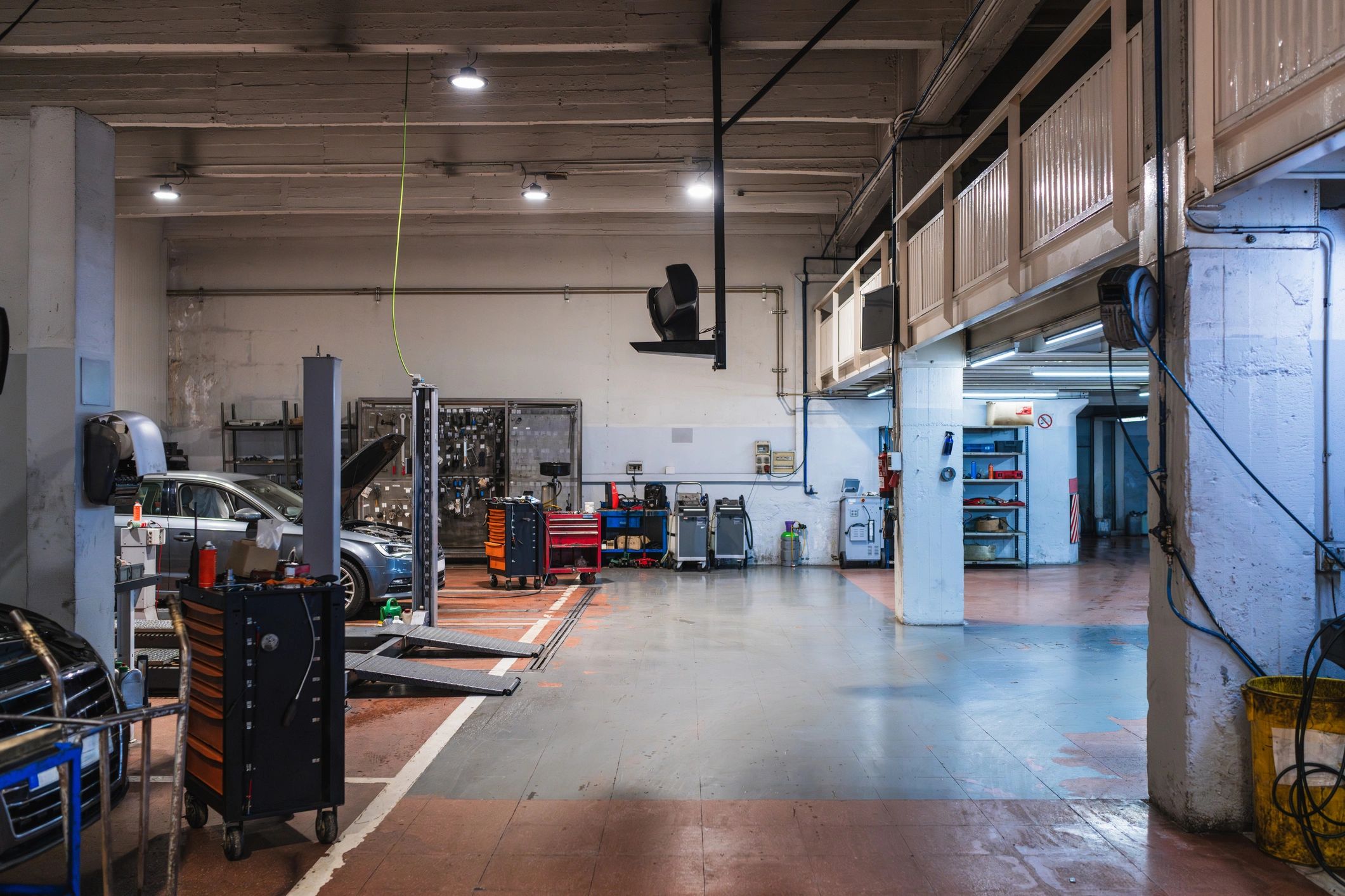Vehicle on a lift inside an auto repair shop